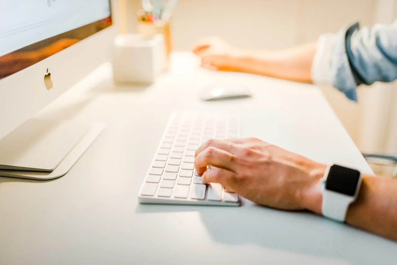 person using iMac working on keyword research